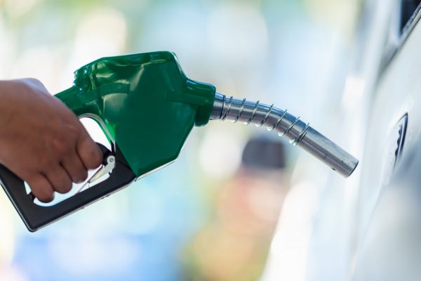 Handle pumping gasoline fuel nozzle to refuel. Vehicle fueling facility at petrol station